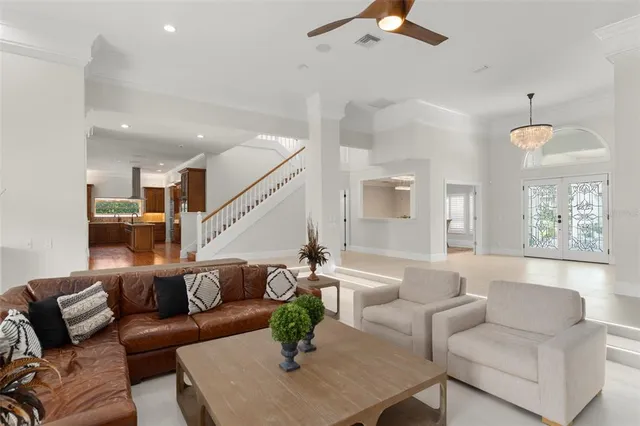 a living room with furniture wooden floor and a chandelier