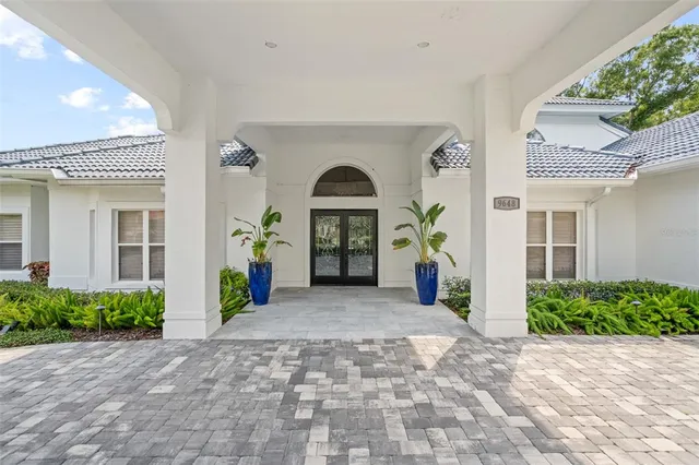 a living room with furniture a flat screen tv and a large window