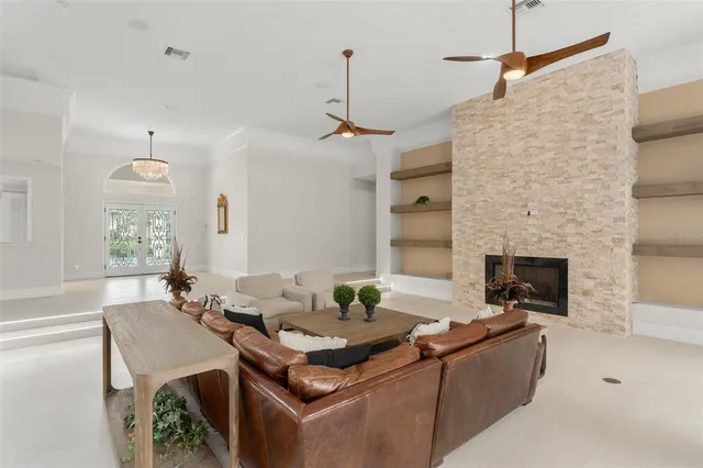 a living room with furniture and a ceiling fan