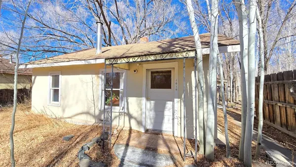 a view of a house with a wooden fence