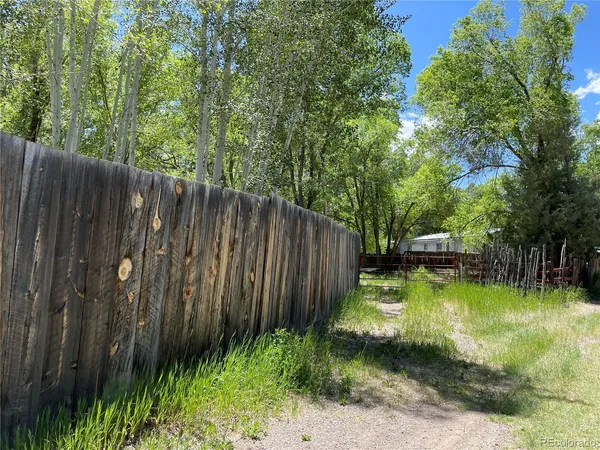 a view of swimming pool with wooden fence