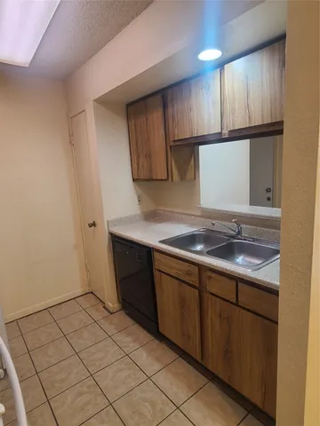 a kitchen with a stove top oven cabinets and a refrigerator