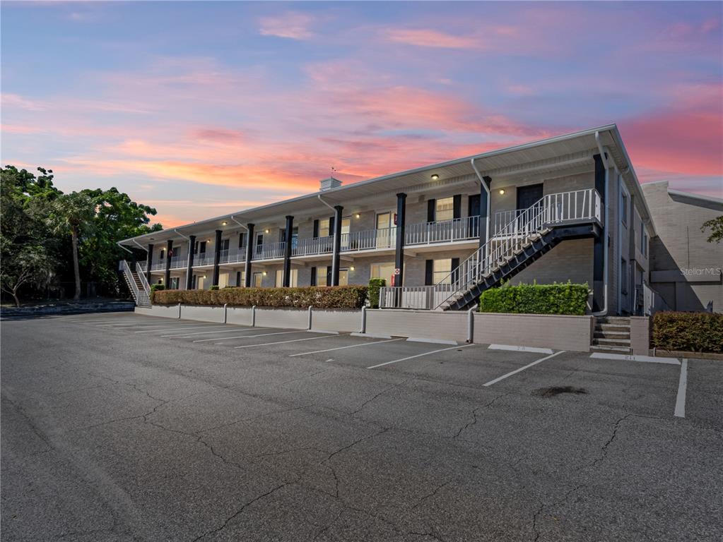 a front view of a house with a yard and potted plants