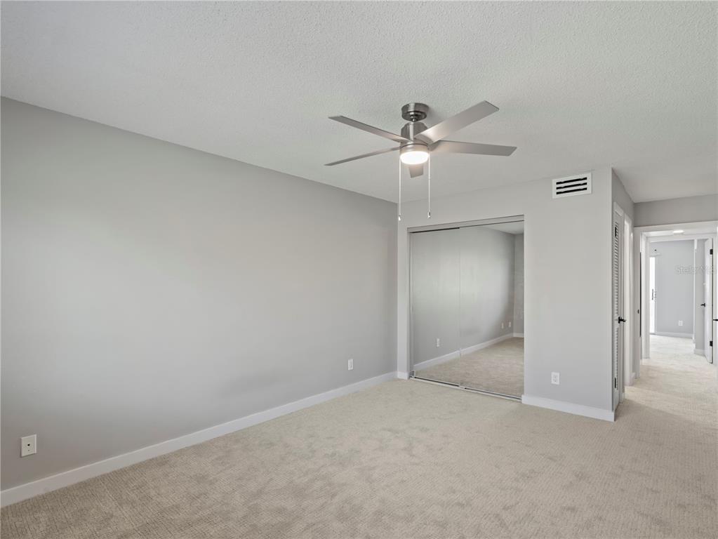 1250 South Denning Drive, Unit 213 Winter Park, FL 32789 - Photo 15 of 20 an empty room with a ceiling fan and a fan