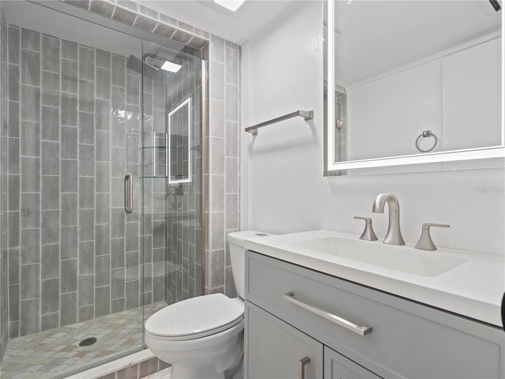 1250 South Denning Drive, Unit 213 Winter Park, FL 32789 - Photo 16 of 20 a bathroom with a sink a toilet and shower