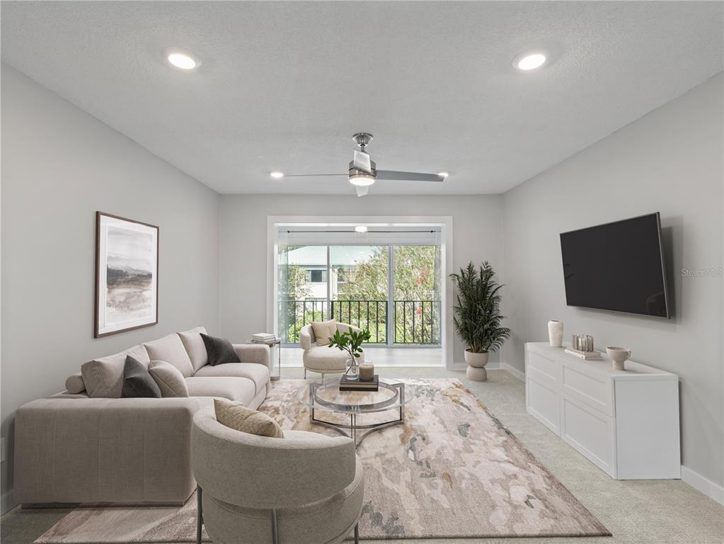 1250 South Denning Drive, Unit 213 Winter Park, FL 32789 - Photo 3 of 20 a living room with furniture and a flat screen tv