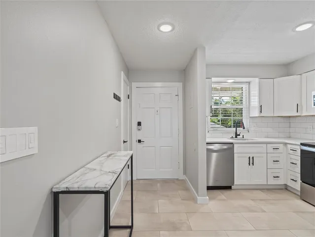 a kitchen with a stove a sink and a refrigerator