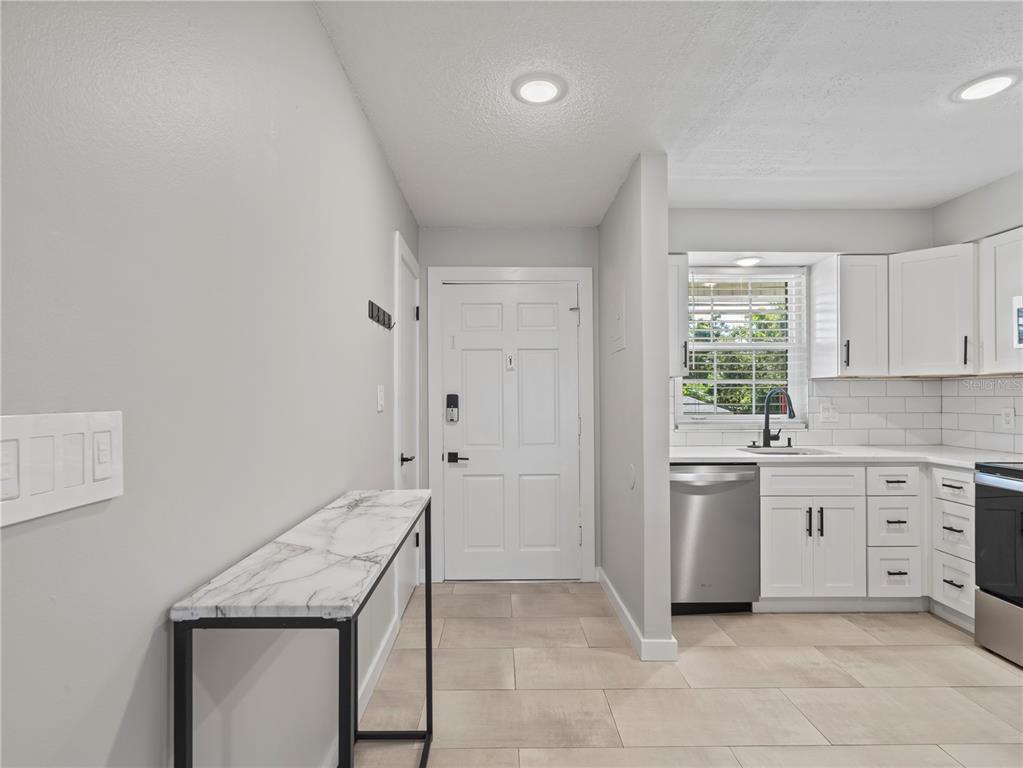 1250 South Denning Drive, Unit 213 Winter Park, FL 32789 - Photo 8 of 20 a kitchen with a stove a sink and a refrigerator