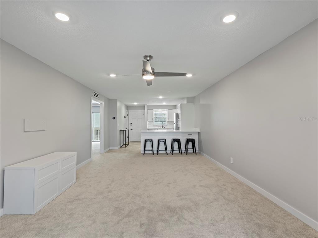 1250 South Denning Drive, Unit 213 Winter Park, FL 32789 - Photo 10 of 20 a view of an empty room with kitchen and a window