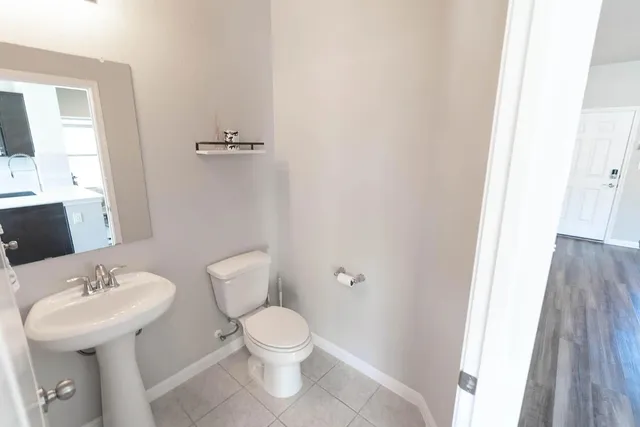 a bathroom with a toilet sink and mirror
