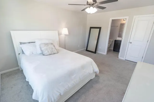 a bedroom with a bed and a mirror