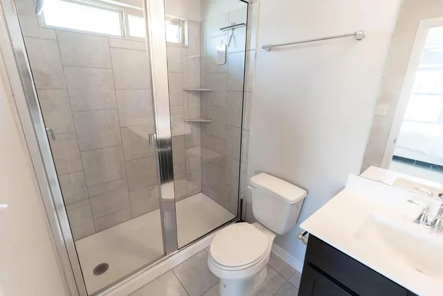 a white toilet sitting next to a bathroom sink