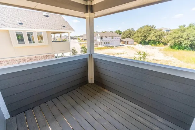 a view of balcony with wooden floor