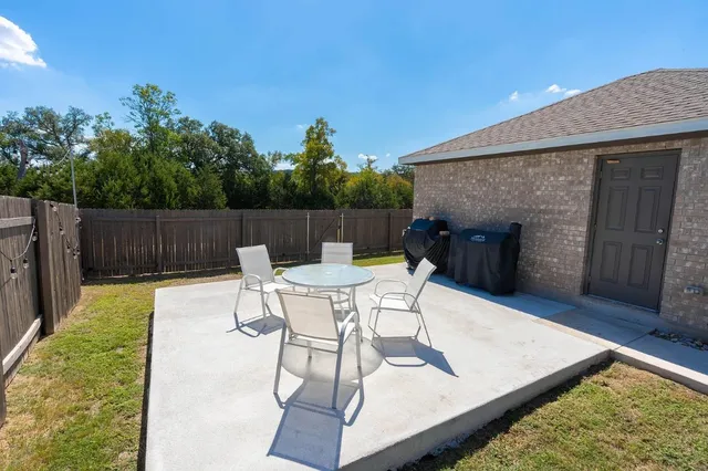 a view of a backyard with furniture