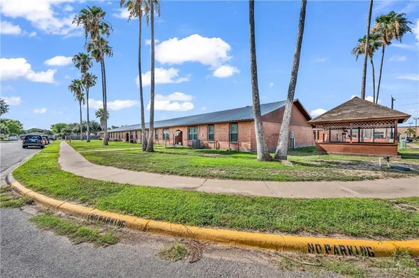 a front view of a house with a yard and lake view