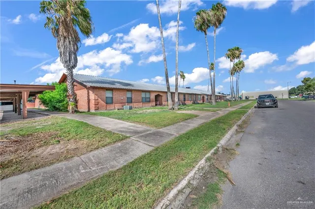 a view of a house with a yard and a garden