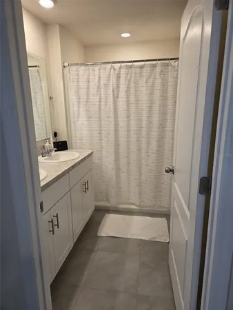 a bathroom with a double vanity sink and mirror