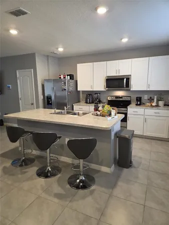 a kitchen with a sink cabinets and stainless steel appliances