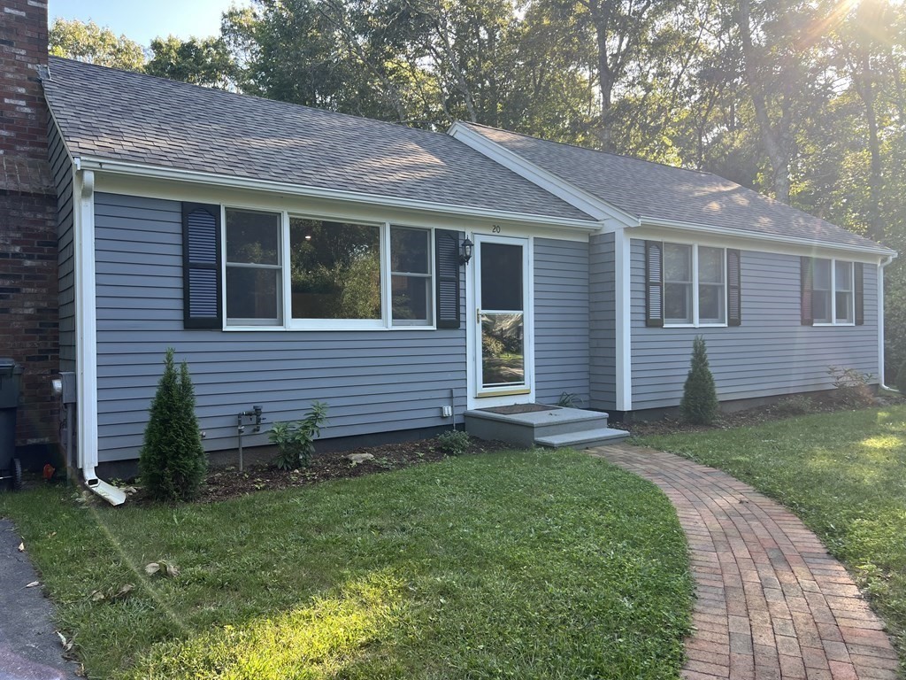 a view of a house with a yard and a garden