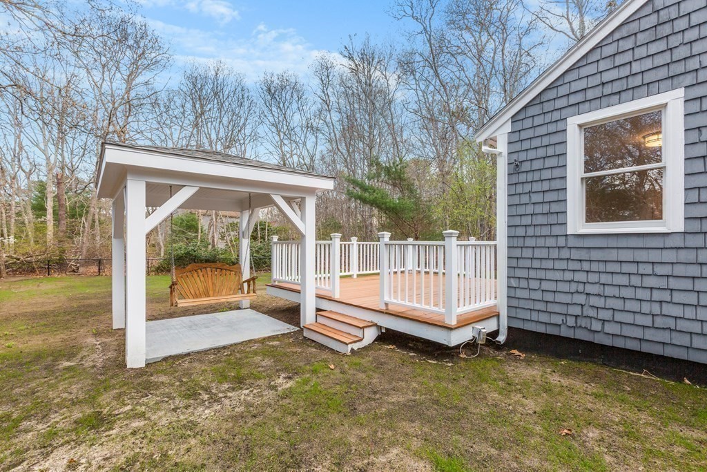 20 Nantucket Trail Sandwich, MA 02563 - Photo 25 of 30 a view of backyard with deck and a garden