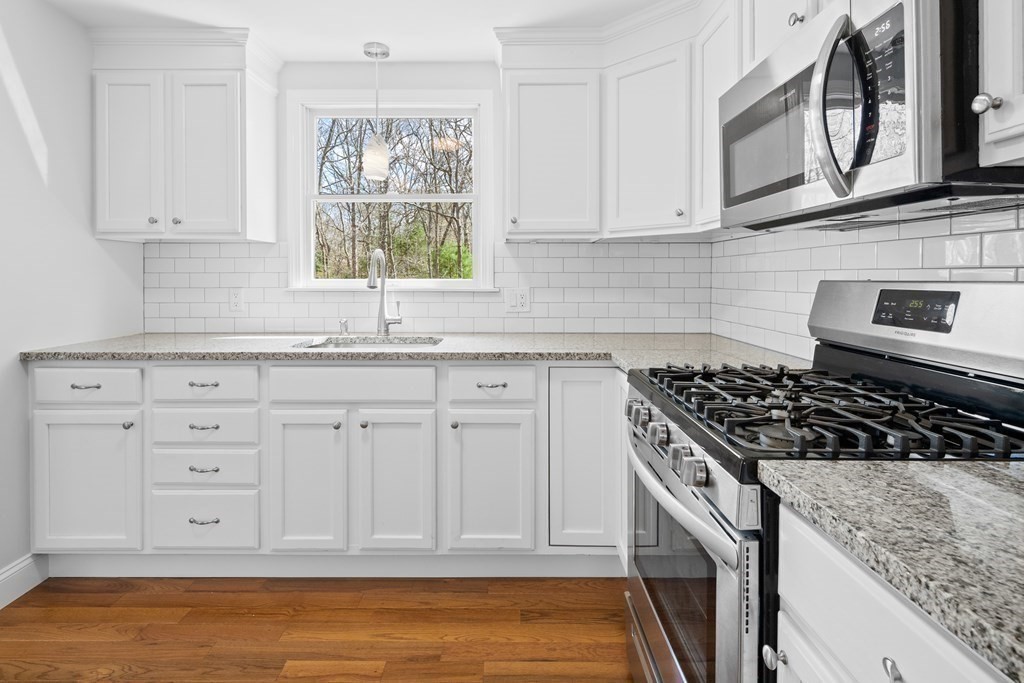 20 Nantucket Trail Sandwich, MA 02563 - Photo 6 of 30 a kitchen with white cabinets and window