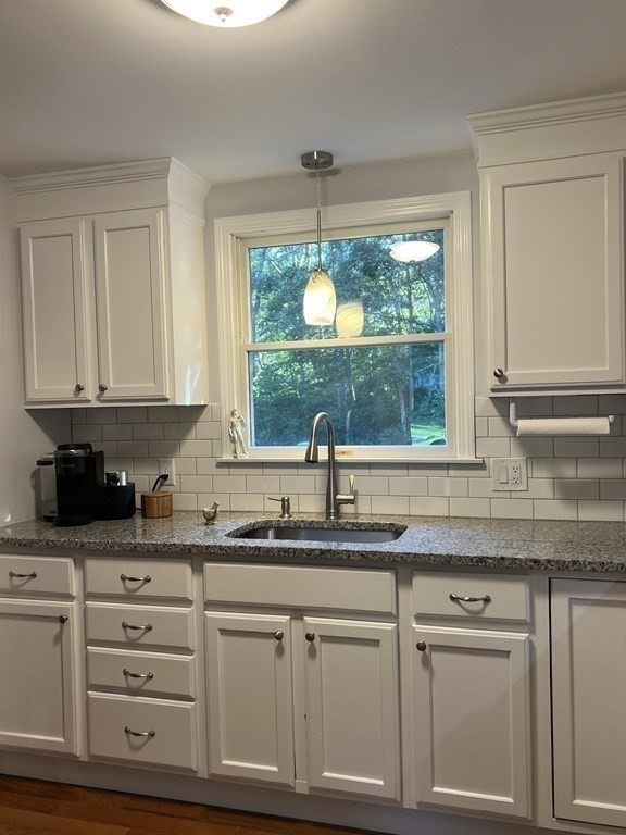 20 Nantucket Trail Sandwich, MA 02563 - Photo 9 of 30 a kitchen with granite countertop a sink window and cabinets