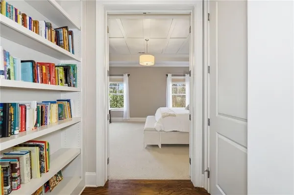 a bedroom with a bed lamp and a large window