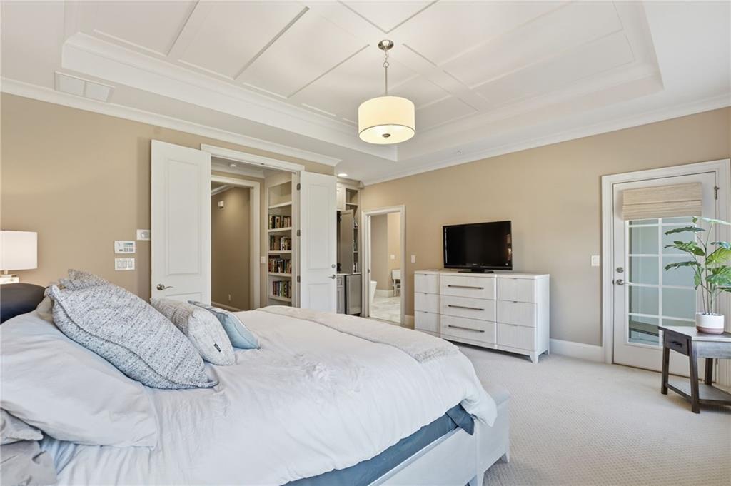 2085 Bellrick Road Northwest Atlanta, GA 30318 - Photo 30 of 78 a bedroom with a large bed and a flat screen tv