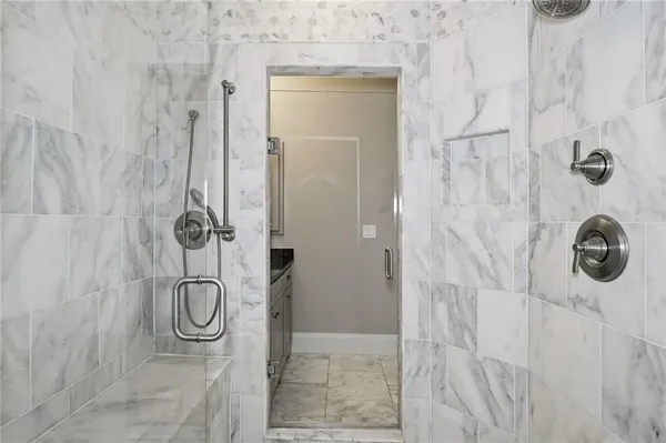 a bathroom with a granite countertop sink toilet and mirror