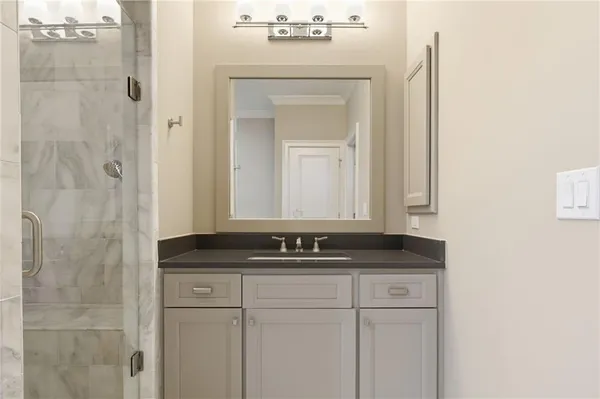 a bathroom with a shower and a sink