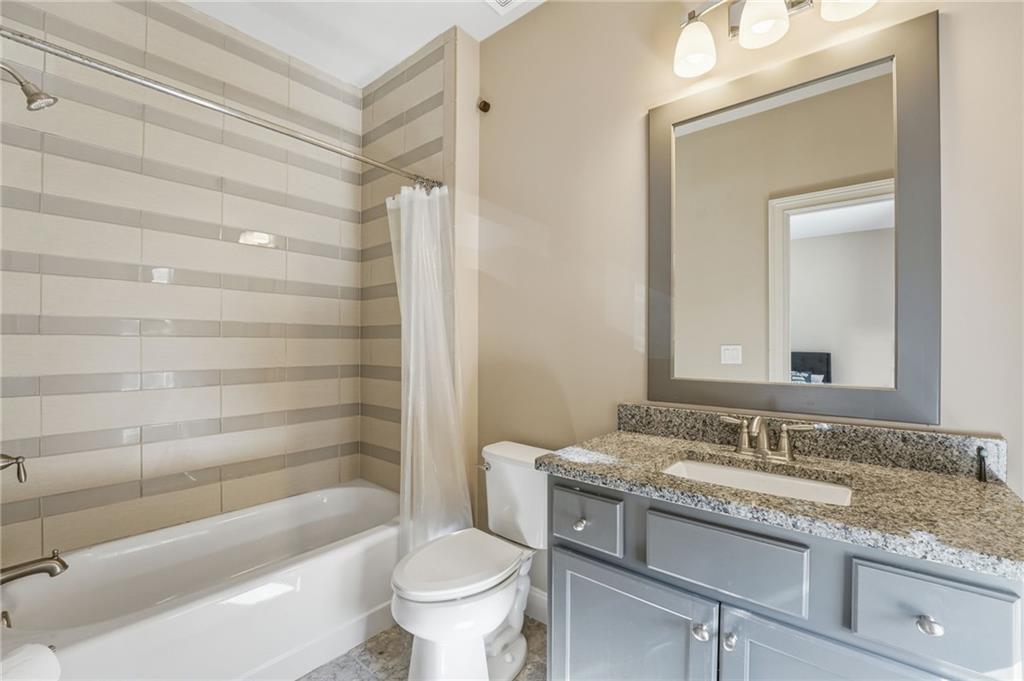 2085 Bellrick Road Northwest Atlanta, GA 30318 - Photo 39 of 78 a bathroom with a granite countertop sink a toilet and bathtub