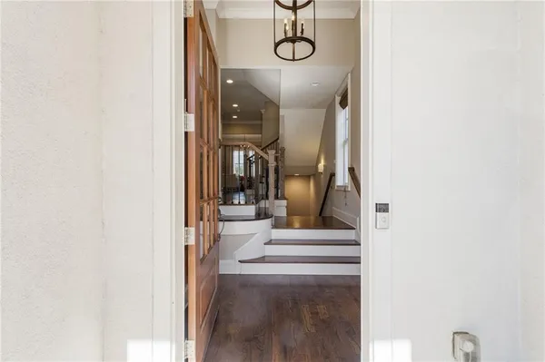 a view of a hallway with wooden floor and entryway