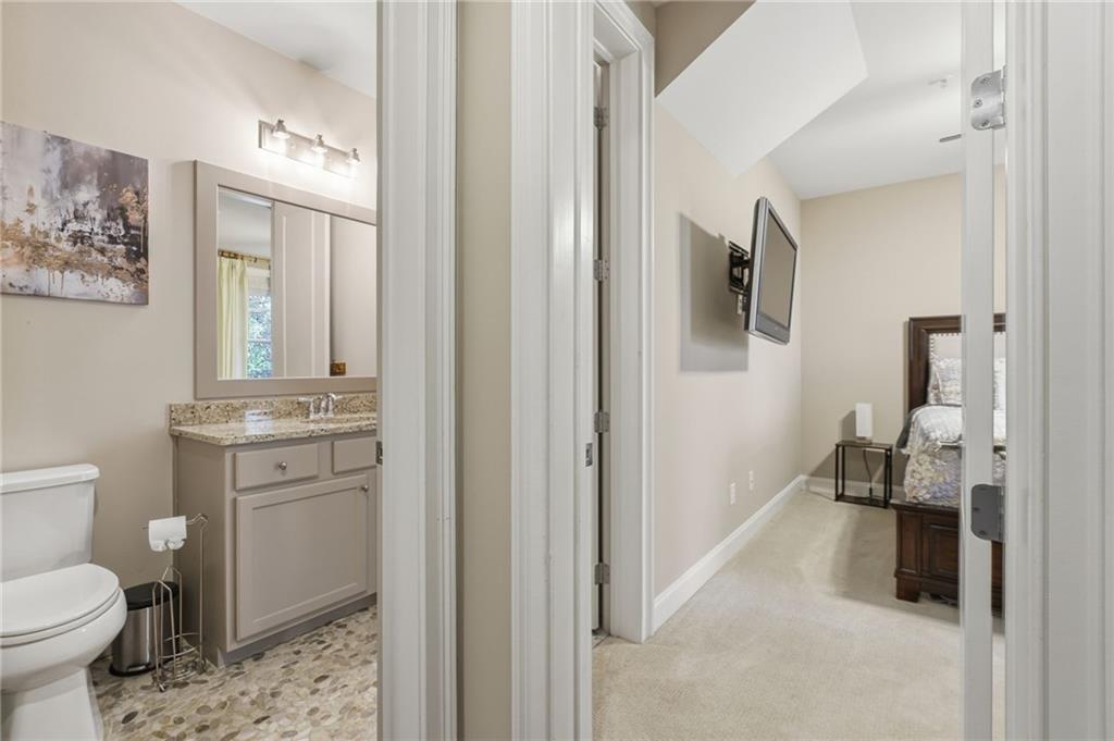 2085 Bellrick Road Northwest Atlanta, GA 30318 - Photo 54 of 78 a bathroom with a toilet sink and mirror