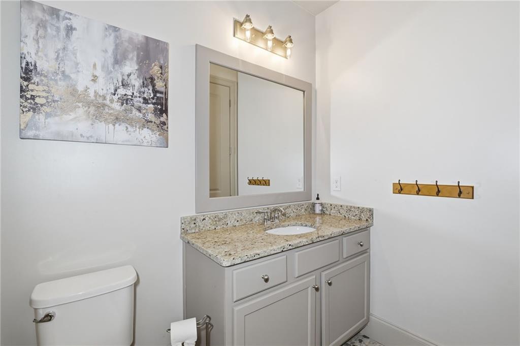 2085 Bellrick Road Northwest Atlanta, GA 30318 - Photo 57 of 78 a bathroom with a granite countertop sink and a mirror