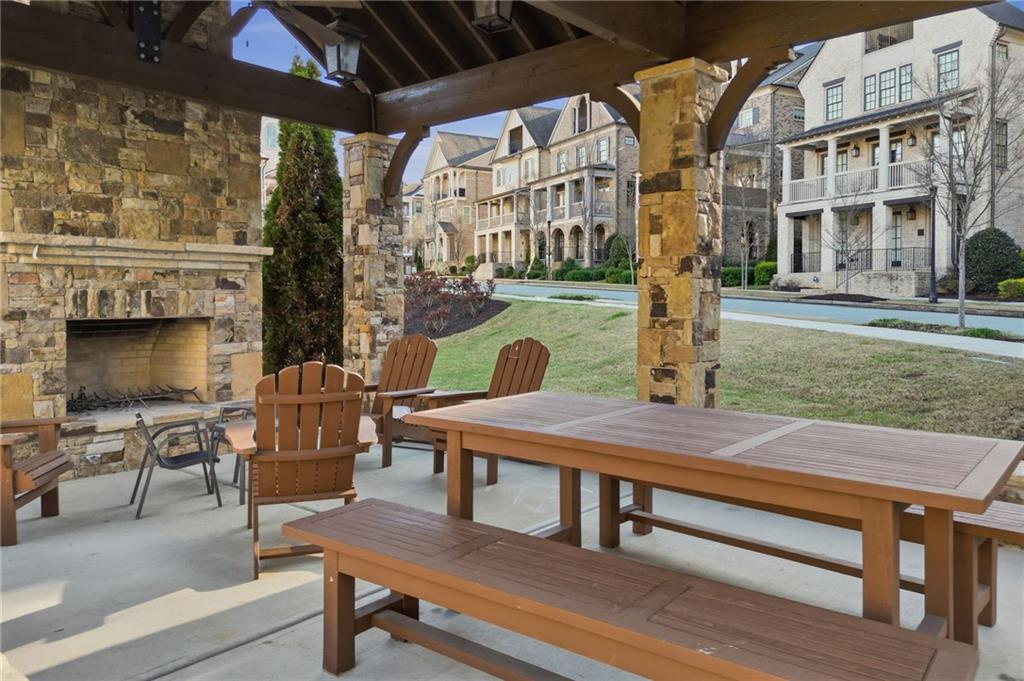 2085 Bellrick Road Northwest Atlanta, GA 30318 - Photo 68 of 78 a view of a patio with table and chairs with wooden floor and fence
