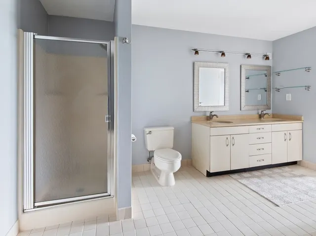 a bathroom with a sink a toilet and a mirror