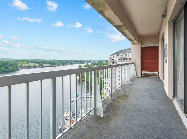 a view of a balcony with wooden floor and fence