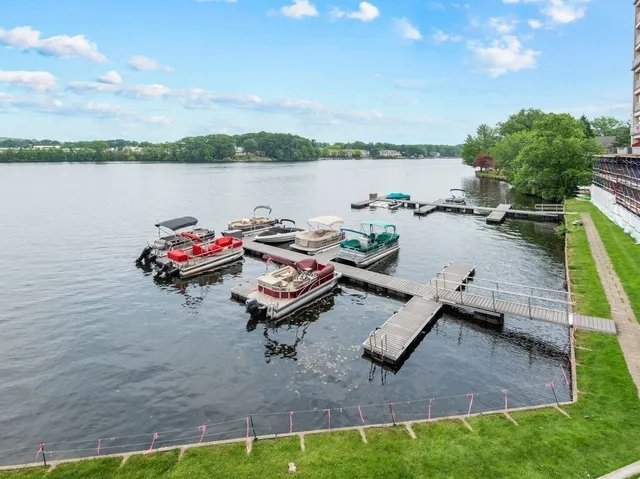 a view of a lake with couches chairs and a table