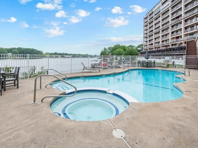 a view of a swimming pool with outdoor space and seating area