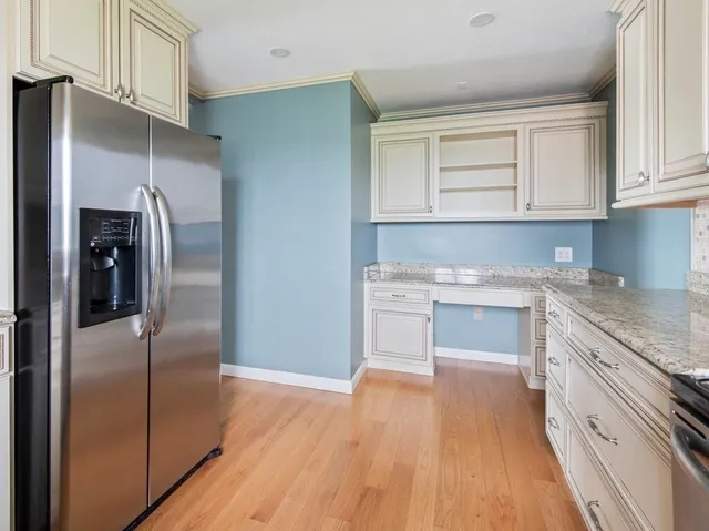 a kitchen with white cabinets and stainless steel appliances