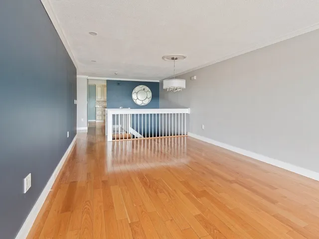 a view of a room with wooden floor