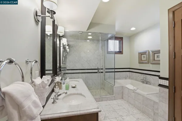 a bathroom with a tub sink and mirror