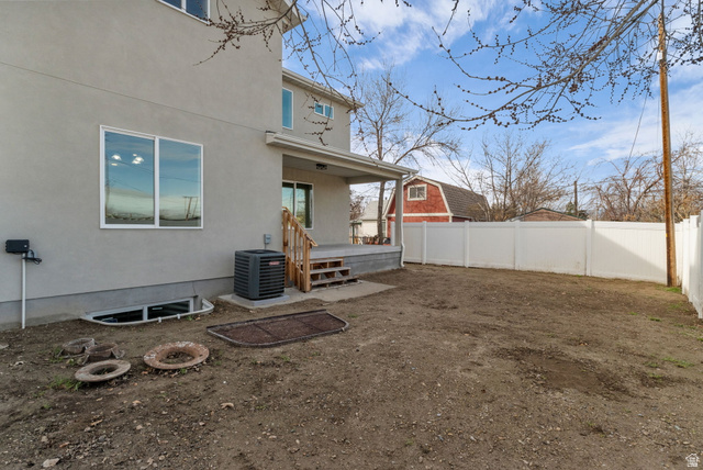 578 West 7th Midvale, UT 84047 - Photo 31 of 35 Back of house featuring a fenced backyard, stucco siding, and a porch