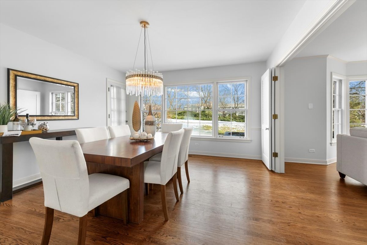 143 Firth Road Inverness, IL 60067 - Photo 11 of 38 a dining room with furniture a chandelier and wooden floor