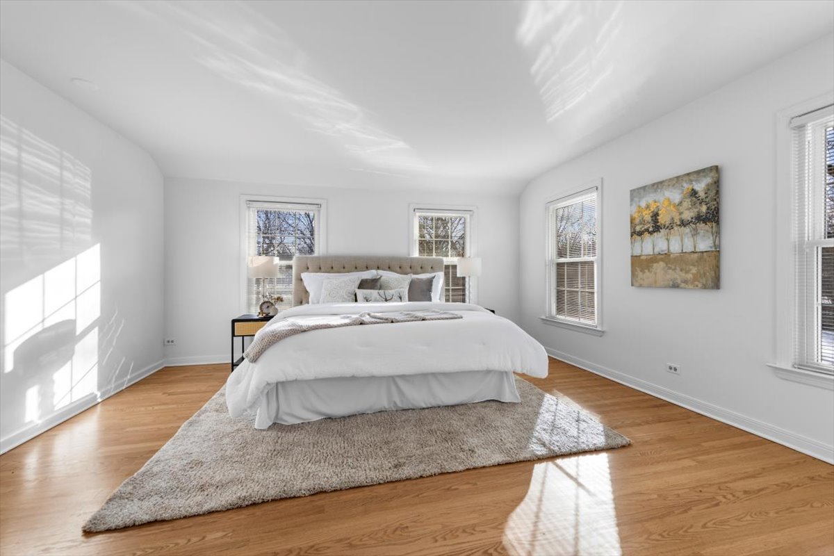 143 Firth Road Inverness, IL 60067 - Photo 23 of 38 a spacious bedroom with a bed and wooden floor