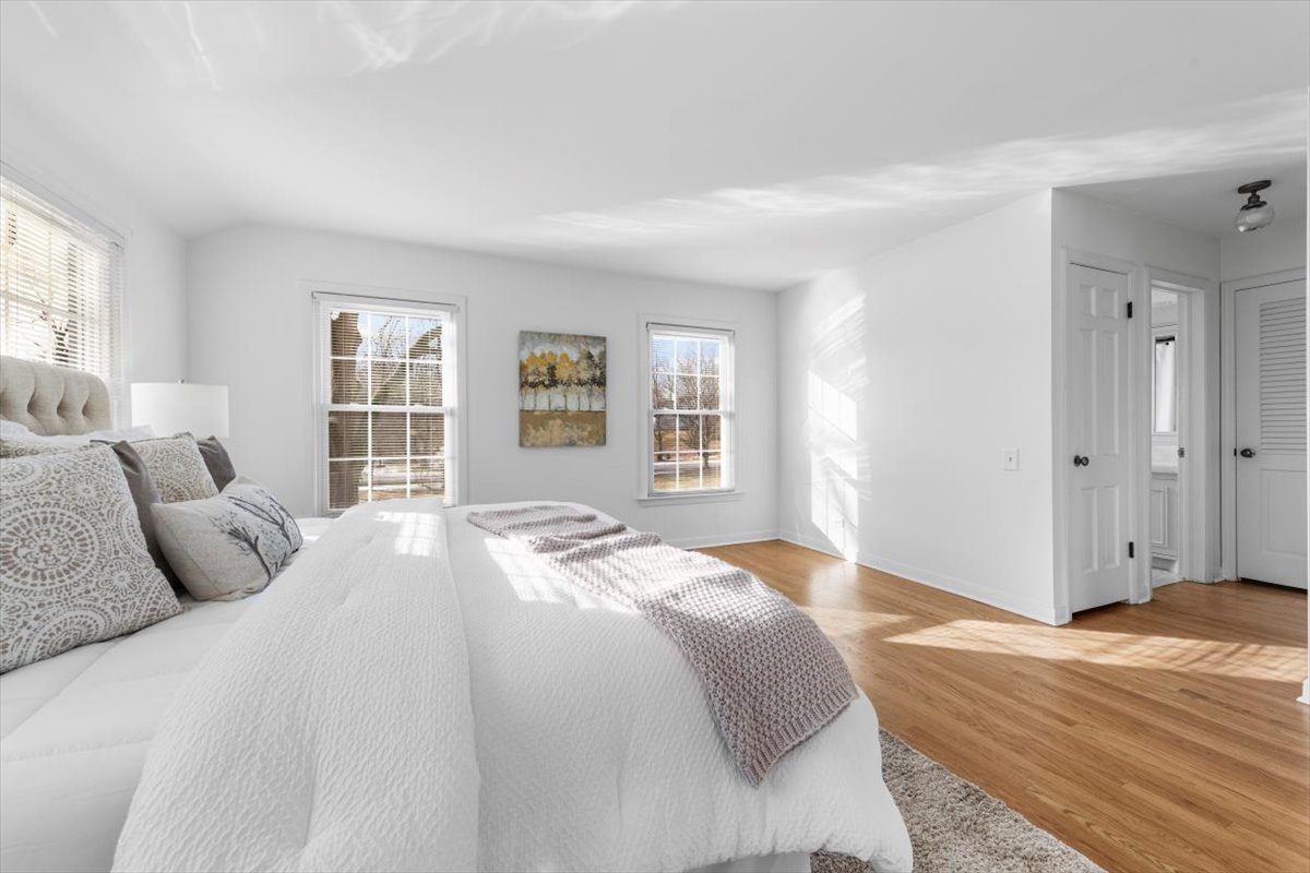 143 Firth Road Inverness, IL 60067 - Photo 24 of 38 a bedroom with a large bed and wooden floor