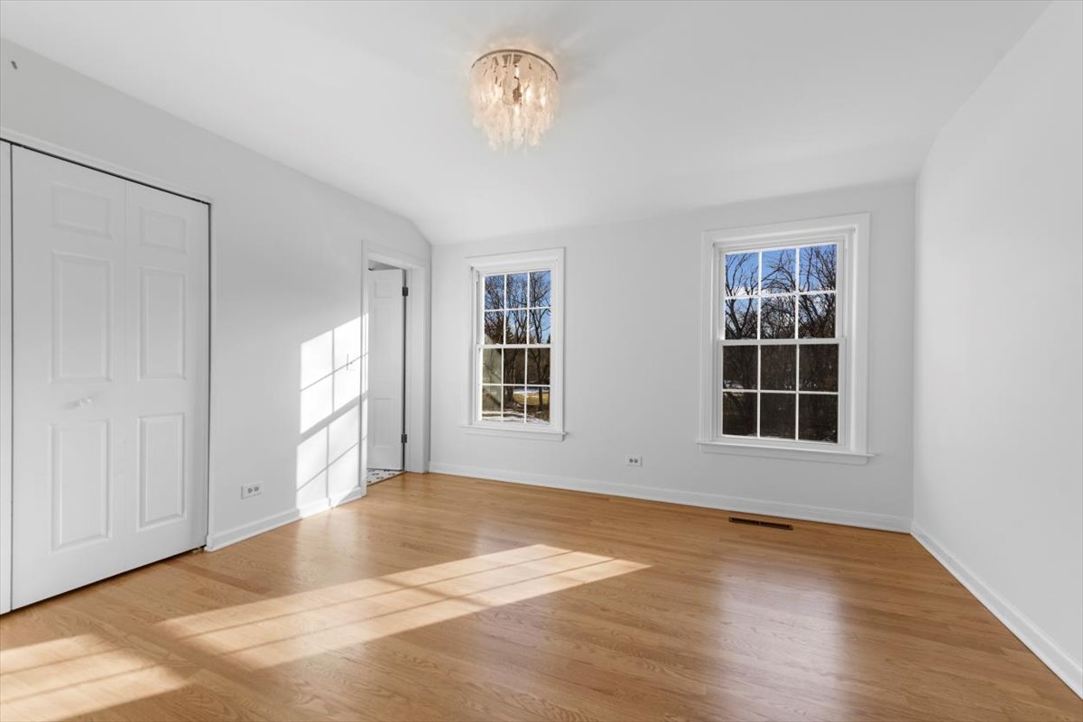 143 Firth Road Inverness, IL 60067 - Photo 26 of 38 a view of an empty room with a window and wooden floor