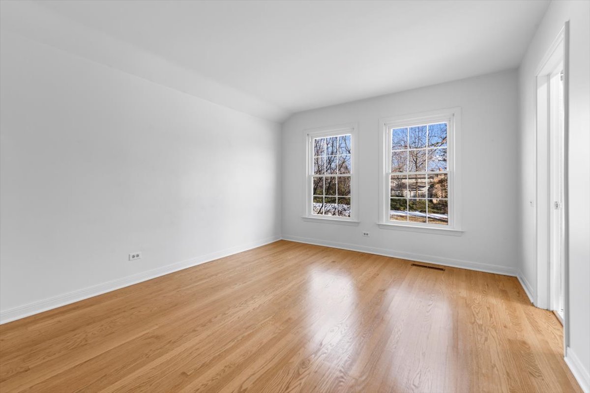 143 Firth Road Inverness, IL 60067 - Photo 28 of 38 an empty room with wooden floor and windows