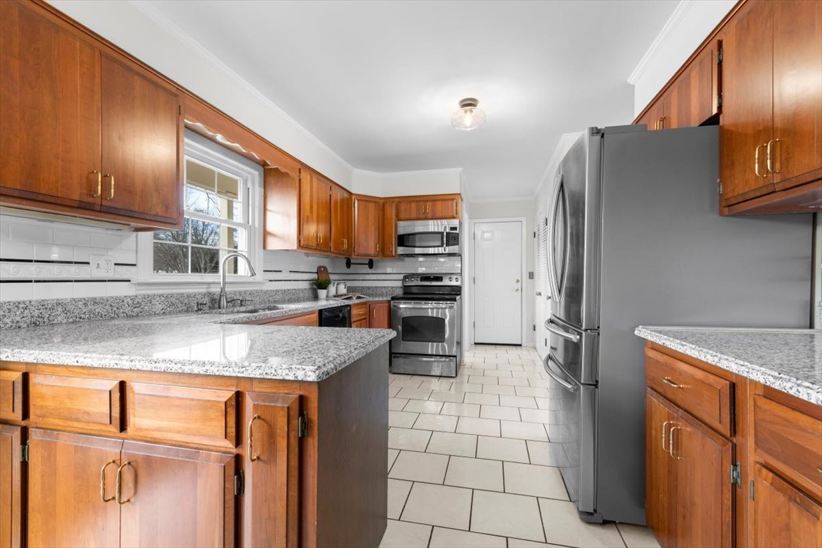 143 Firth Road Inverness, IL 60067 - Photo 5 of 38 a kitchen with stainless steel appliances granite countertop a refrigerator a stove a sink a microwave and island