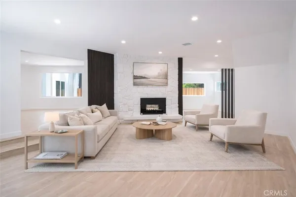 a living room with furniture and a fireplace